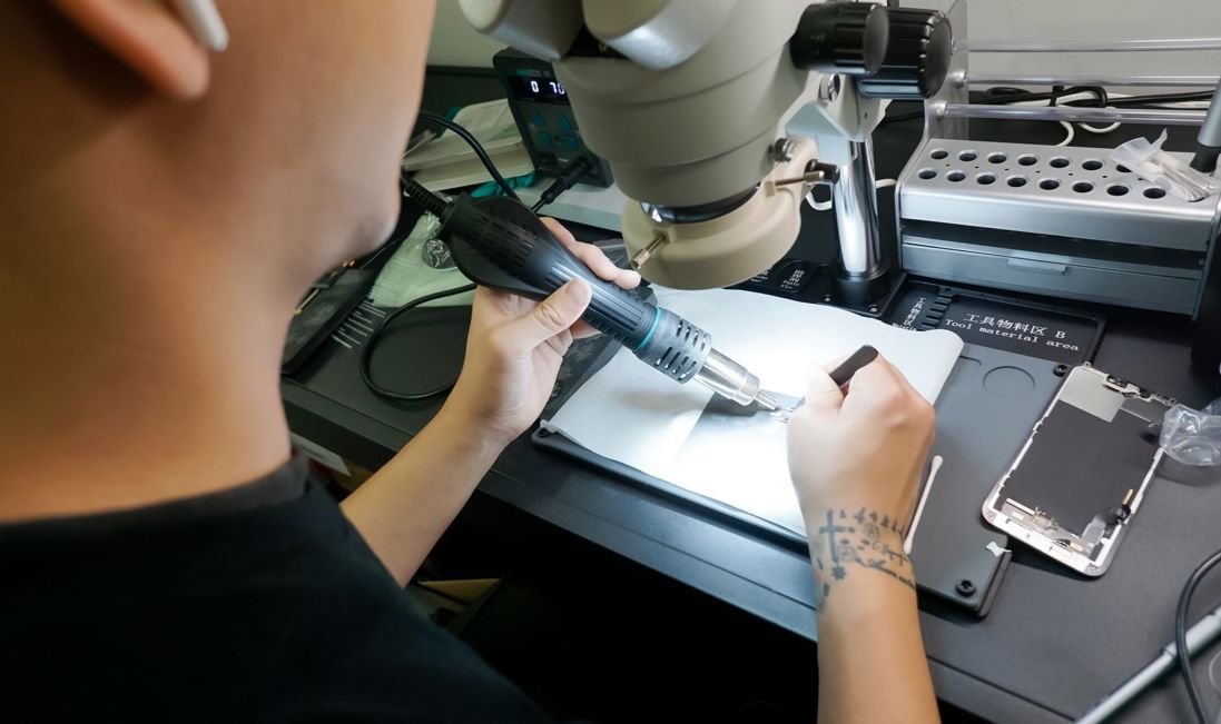 worker solding mobile phone repair