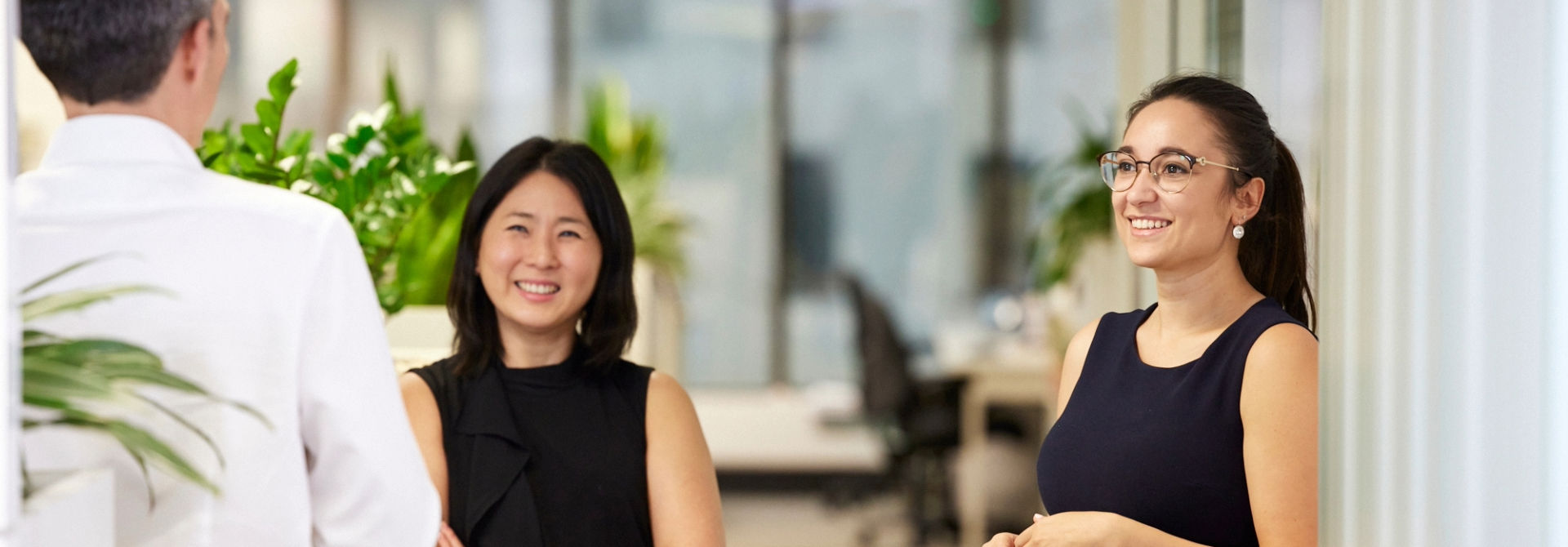 office workers talking at a desk