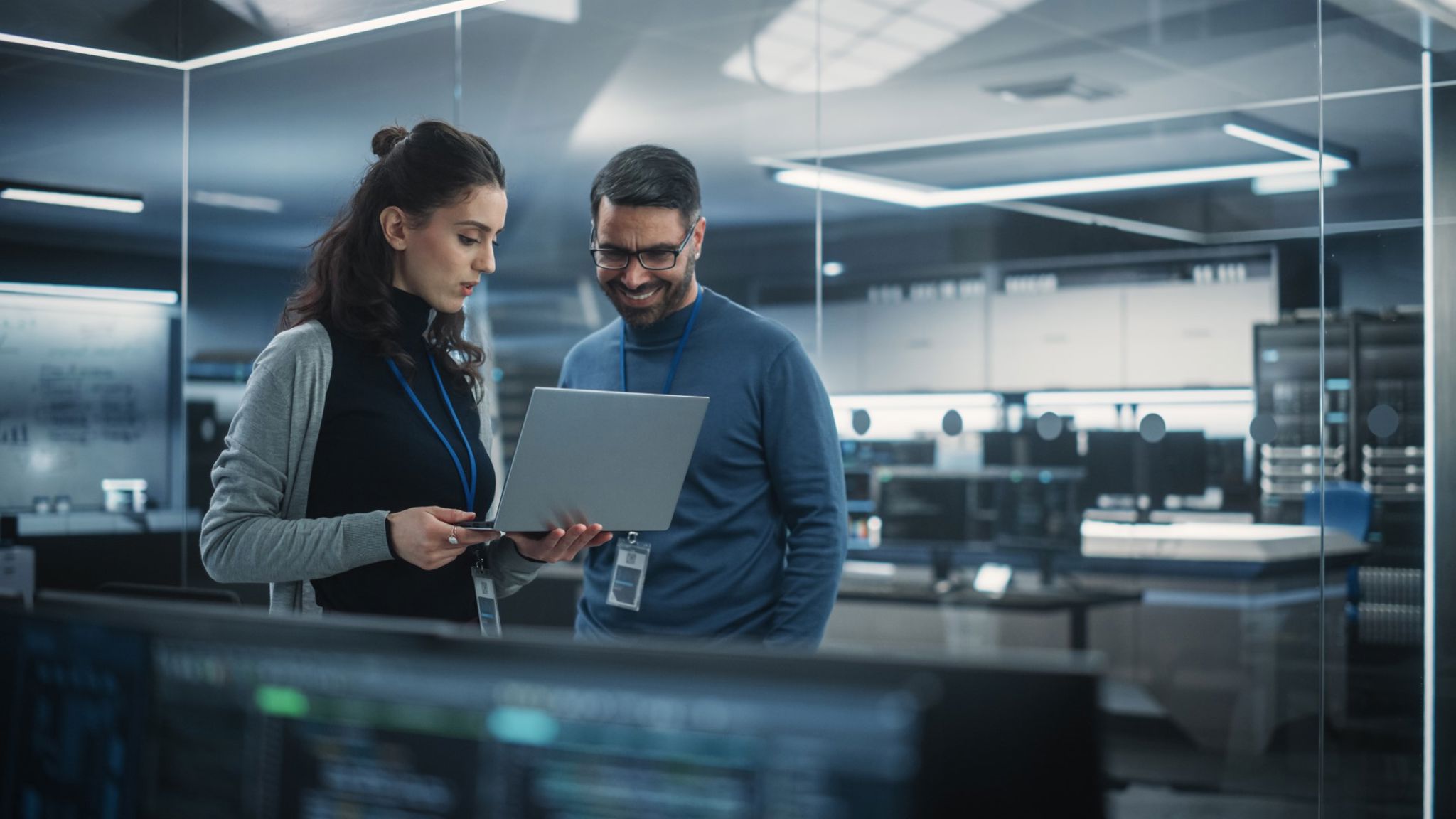 two people collaborating in front of a monitor