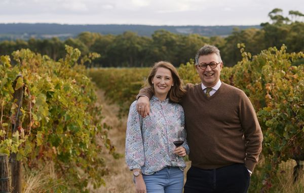 A couple standing in a vineyard