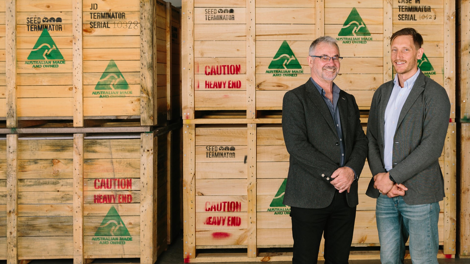 two men standing in front of boxes